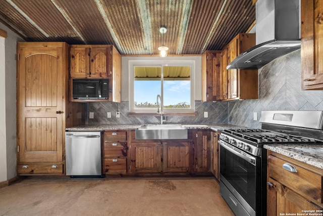 kitchen featuring wall chimney range hood, backsplash, sink, and appliances with stainless steel finishes