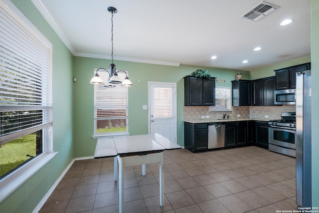 kitchen featuring light tile patterned floors, crown molding, stainless steel appliances, tasteful backsplash, and decorative light fixtures