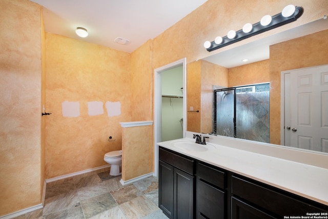 bathroom with walk in shower, vanity, and toilet