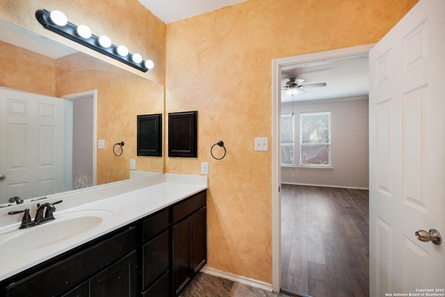 bathroom featuring ceiling fan, vanity, and hardwood / wood-style floors