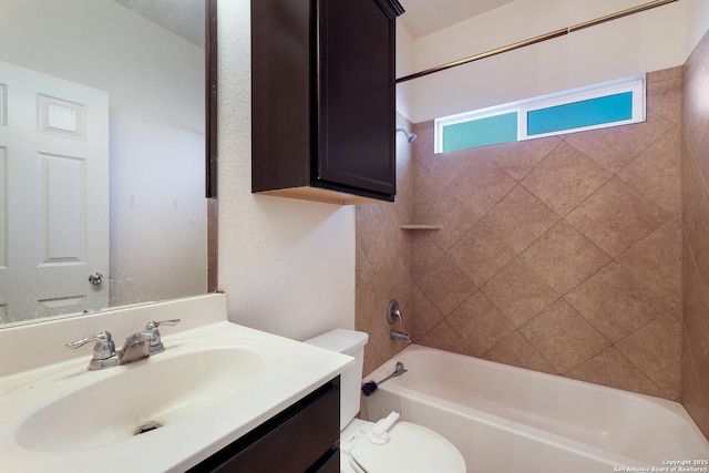 full bathroom featuring vanity, toilet, and tiled shower / bath