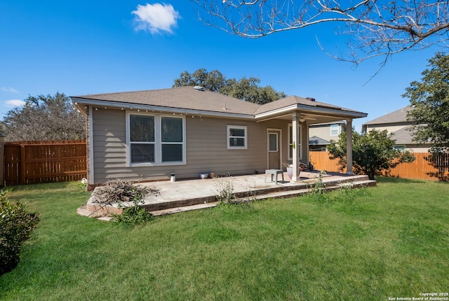 back of house featuring a yard and a patio area