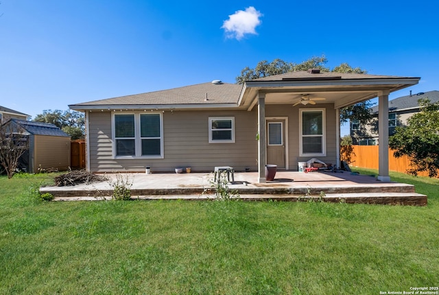 back of house featuring ceiling fan, a storage unit, a yard, and a patio area