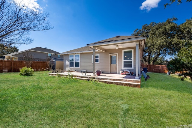 rear view of house with a lawn, ceiling fan, and a patio area