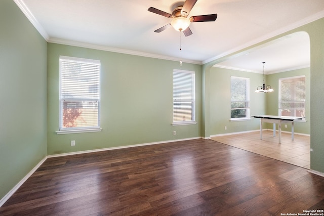 unfurnished room with ornamental molding, a healthy amount of sunlight, and dark hardwood / wood-style flooring