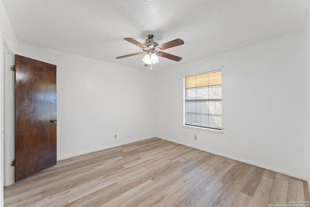 spare room featuring ceiling fan, a textured ceiling, and light hardwood / wood-style floors