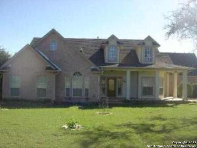 view of front of home featuring a porch and a front lawn