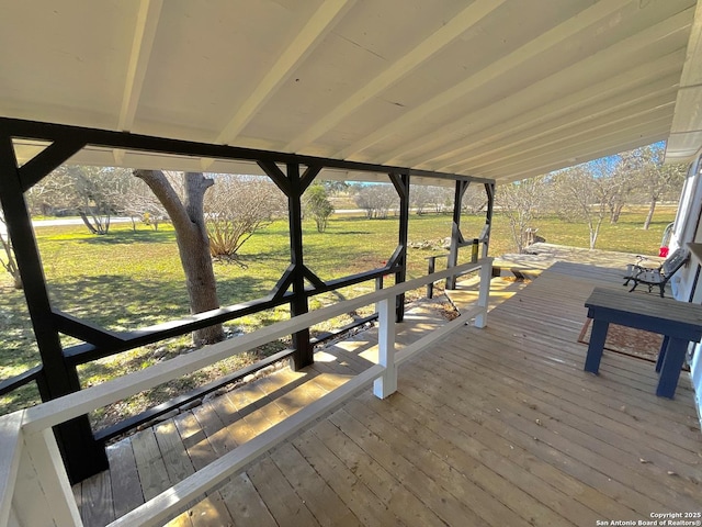 wooden deck featuring a lawn