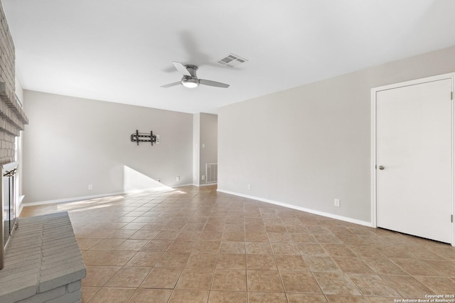 unfurnished living room with ceiling fan, light tile patterned floors, and a fireplace