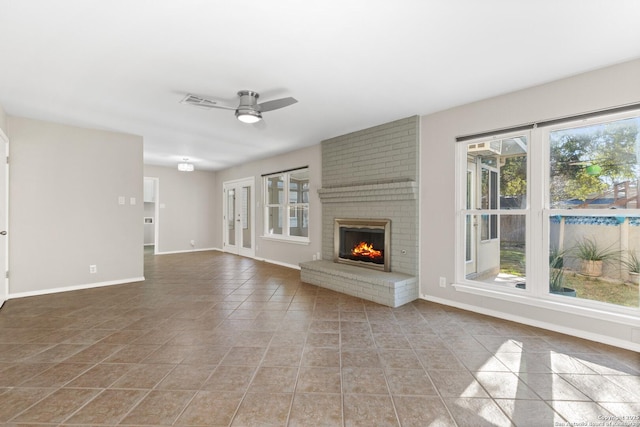 unfurnished living room with light tile patterned floors, a fireplace, and ceiling fan