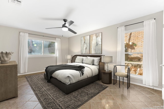 tiled bedroom with ceiling fan