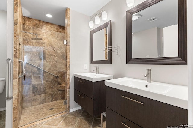 bathroom with vanity, tile patterned flooring, and a shower with shower door