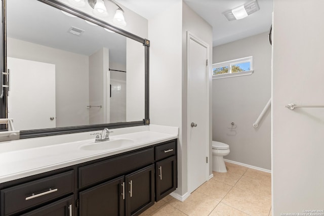 bathroom featuring vanity, toilet, and tile patterned flooring