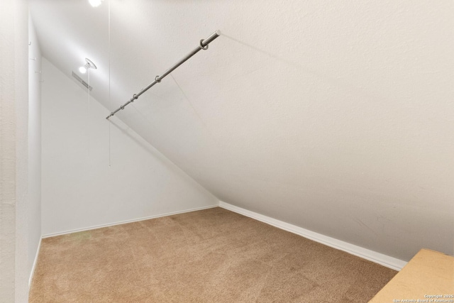 spacious closet featuring vaulted ceiling and carpet