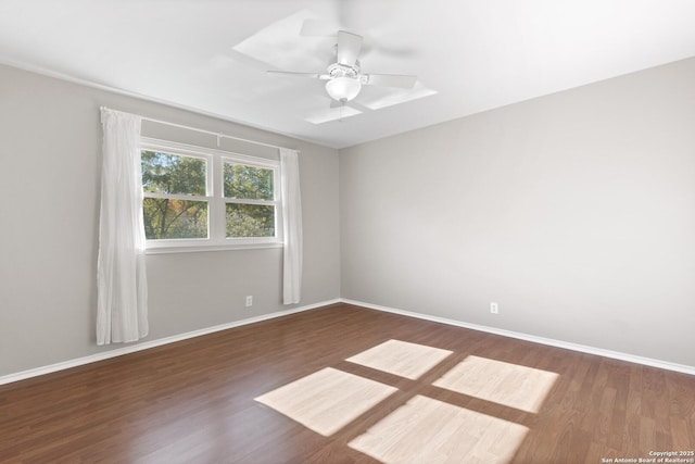 unfurnished room featuring ceiling fan and dark hardwood / wood-style floors