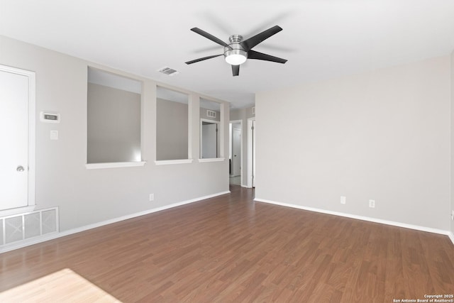 unfurnished room featuring dark wood-type flooring and ceiling fan