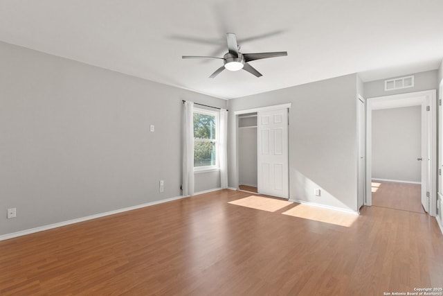 unfurnished bedroom featuring light hardwood / wood-style flooring, a closet, and ceiling fan