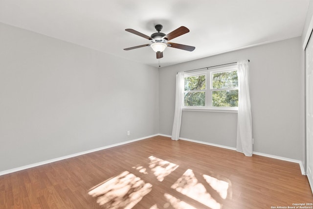 unfurnished room with ceiling fan and light wood-type flooring