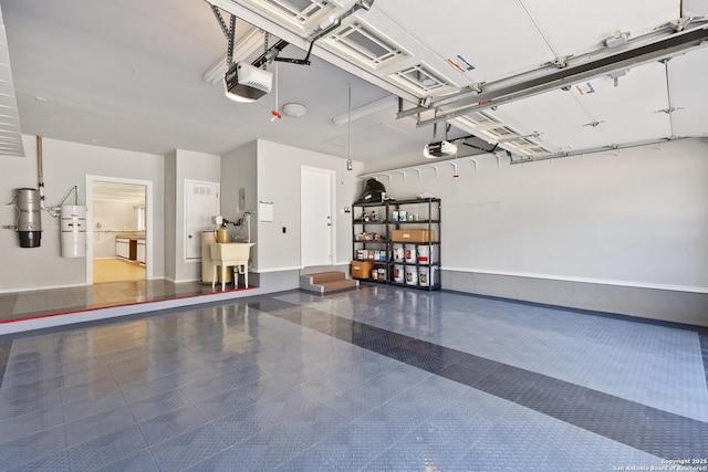 garage featuring sink and a garage door opener