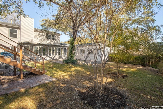 view of yard with an outbuilding and a sunroom