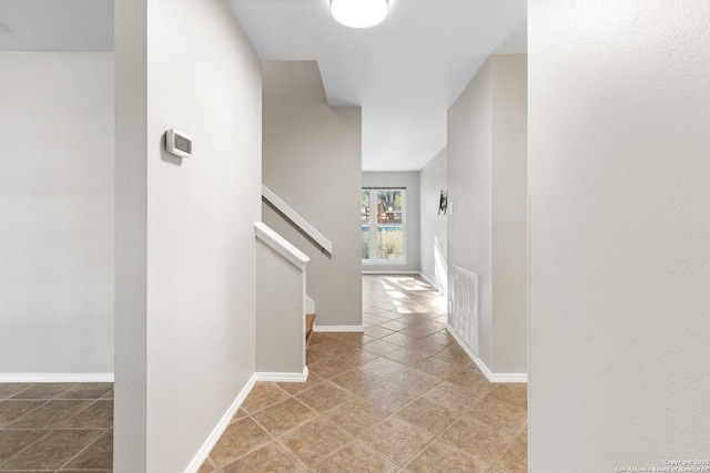 hall featuring light tile patterned floors