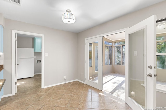 doorway to outside featuring french doors and light tile patterned flooring