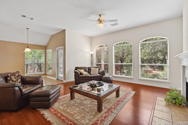 living room featuring hardwood / wood-style flooring, ceiling fan, and lofted ceiling
