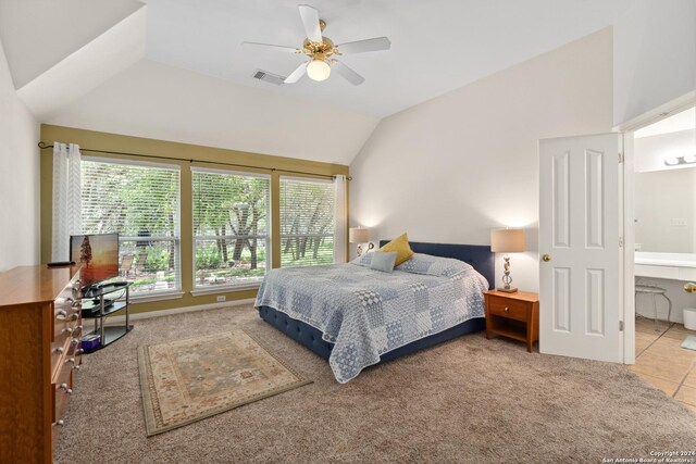 bedroom featuring lofted ceiling, carpet floors, ceiling fan, and ensuite bath