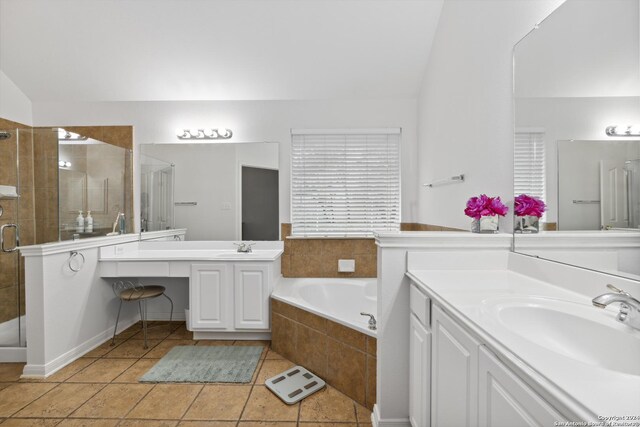 bathroom with vanity, vaulted ceiling, tile patterned floors, and shower with separate bathtub