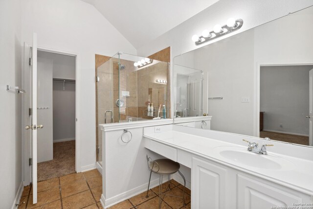 bathroom featuring vaulted ceiling, an enclosed shower, and vanity