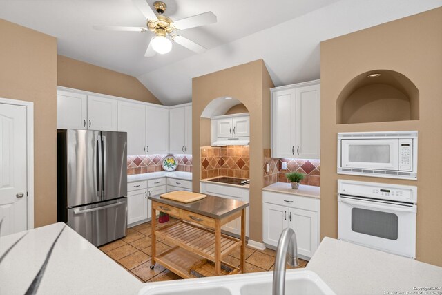 kitchen featuring backsplash, white appliances, sink, and white cabinets