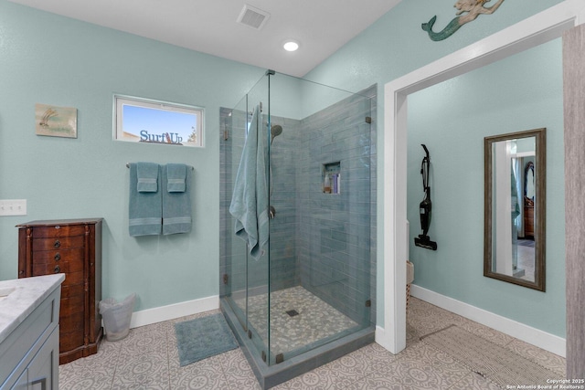 bathroom with tile patterned flooring, vanity, and walk in shower