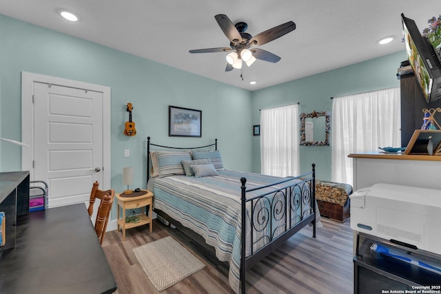 bedroom featuring hardwood / wood-style floors and ceiling fan