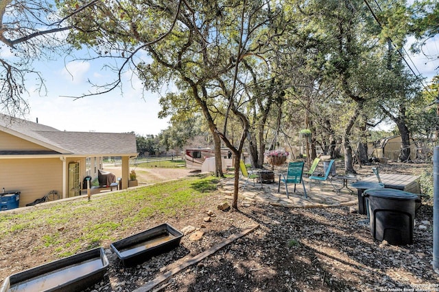 view of yard with an outdoor fire pit, a jacuzzi, and a patio