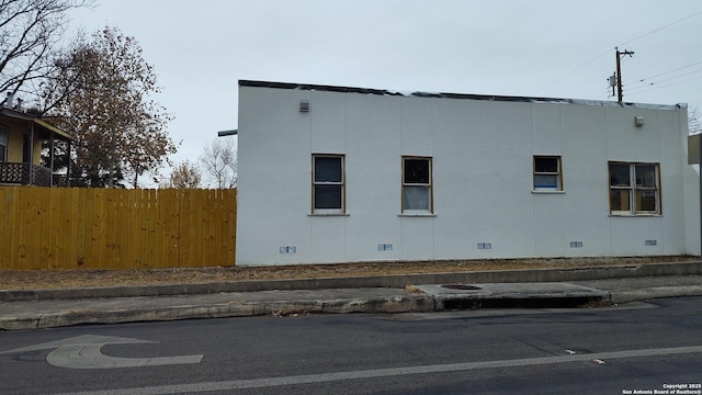 1601 Fulton Ave, San Antonio, TX 78201 - view of side of home with crawl space, fence, and stucco siding