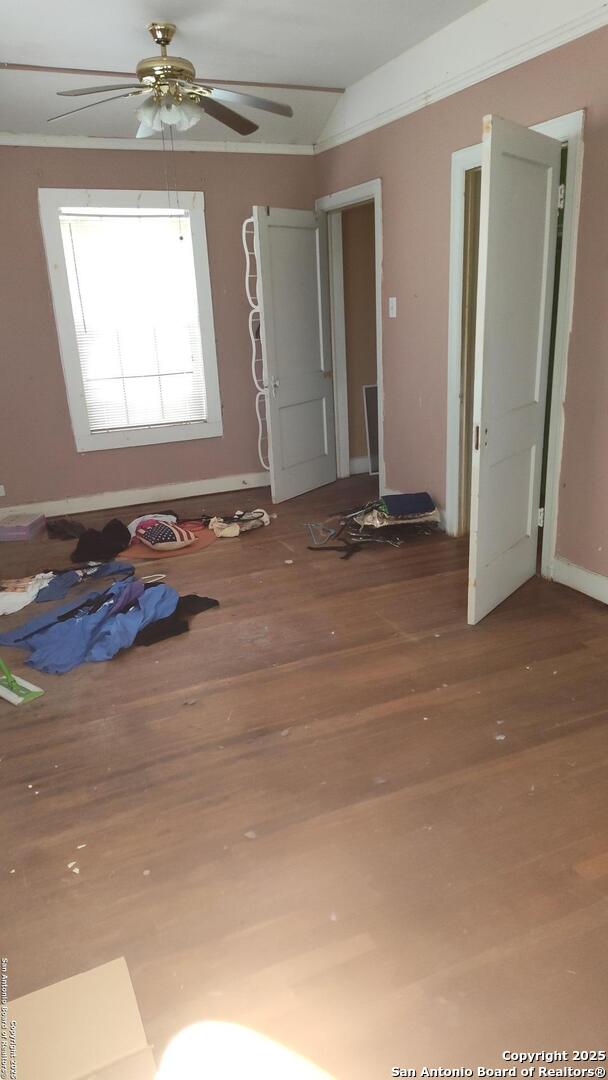 1601 Fulton Ave, San Antonio, TX 78201 - unfurnished room with wood finished floors, a ceiling fan, and baseboards