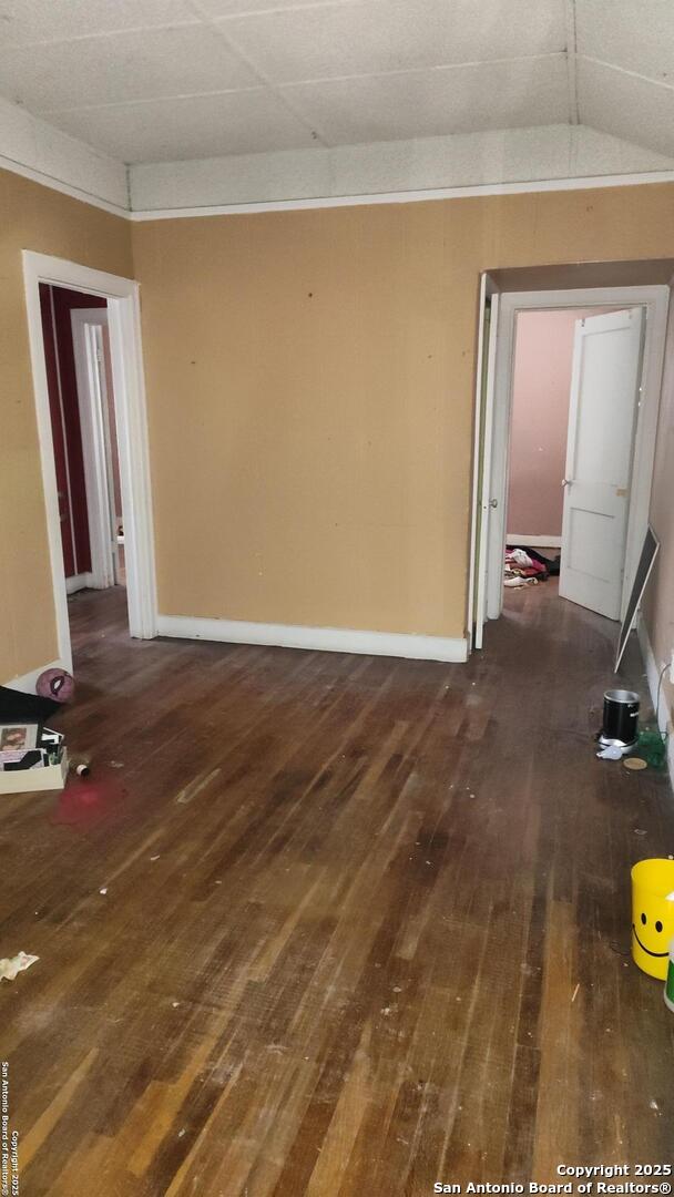 1601 Fulton Ave, San Antonio, TX 78201 - spare room featuring wood-type flooring, baseboards, and lofted ceiling