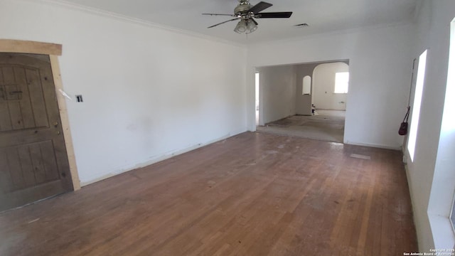 1601 Fulton Ave, San Antonio, TX 78201 - spare room featuring arched walkways, a ceiling fan, crown molding, wood finished floors, and baseboards