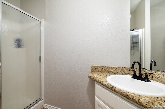 bathroom with vanity and an enclosed shower