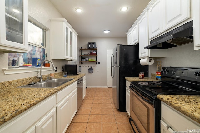 kitchen featuring sink, white cabinetry, light stone counters, light tile patterned floors, and stainless steel appliances