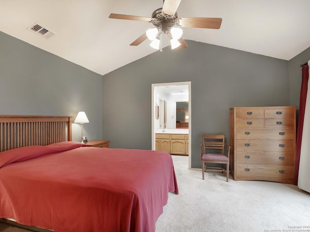 carpeted bedroom featuring vaulted ceiling, connected bathroom, and ceiling fan