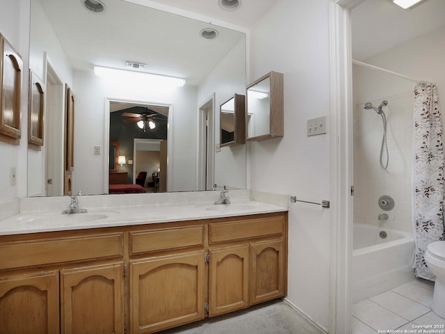 full bathroom with shower / bath combination with curtain, tile patterned flooring, vanity, ceiling fan, and toilet