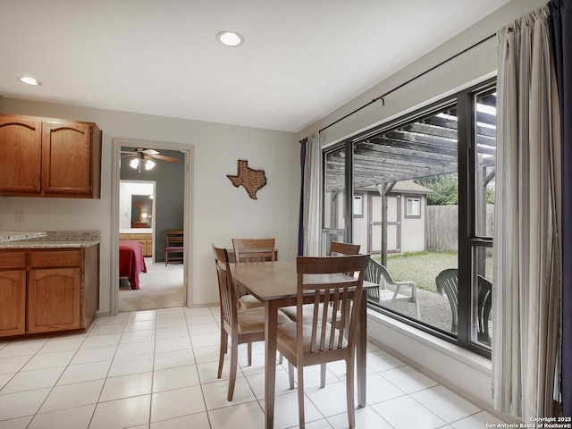 tiled dining area with ceiling fan