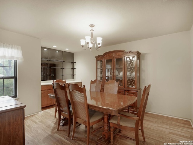 dining room featuring an inviting chandelier and light wood-type flooring