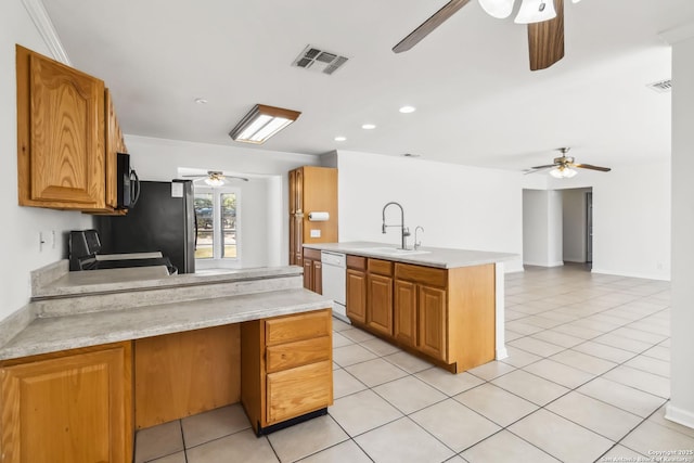 kitchen featuring light tile patterned flooring, stainless steel refrigerator, dishwasher, sink, and range