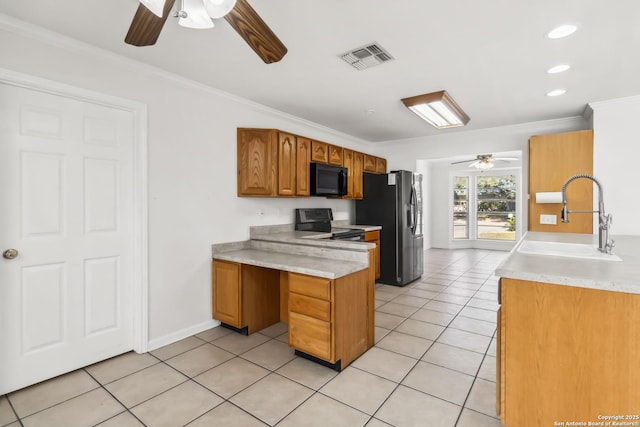 kitchen featuring sink, crown molding, and black appliances