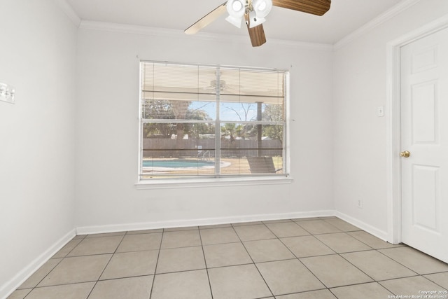 tiled spare room with ornamental molding and ceiling fan