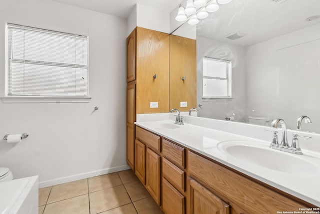 bathroom featuring vanity, tile patterned floors, and toilet