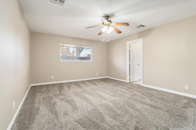 carpeted spare room featuring ceiling fan