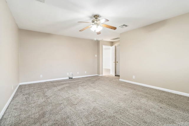 carpeted spare room featuring ceiling fan